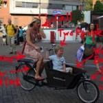Dutch mom cycling on bakfiets