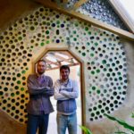 Francesco and Joaquin at the upcycled glass bottle wall