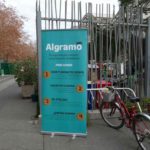 The Algramo refilling tricycle is parked next to the municipal recycling station