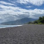 Black sand on the beach reveals Tahiti's volcanic origin