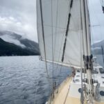 Sailing along Fiordlands impressive mountains